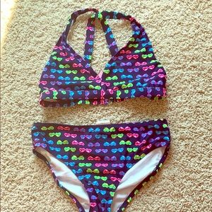 Cross back bikini set with sunglasses design.
